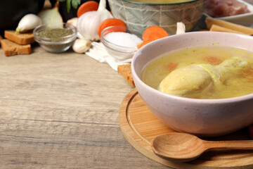 Concept of cooking chicken soup or broth on wooden background