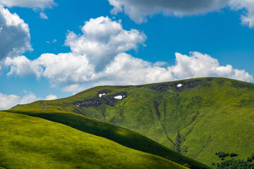 Green Summer Mountains Hills with White Clouds on Blue Sky