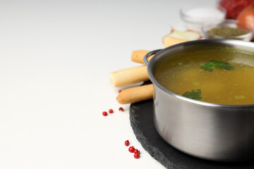 Concept of tasty food with chicken soup or broth on white background