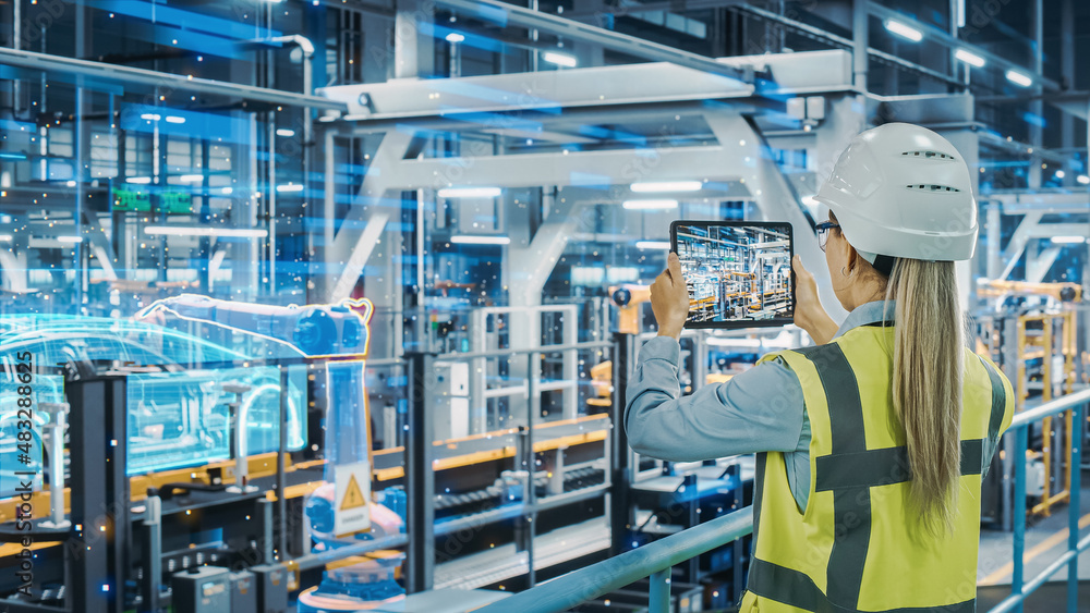 Leinwandbilder futuristic car factory digitalization industry 4.0: female automotive engineer using augmented reali