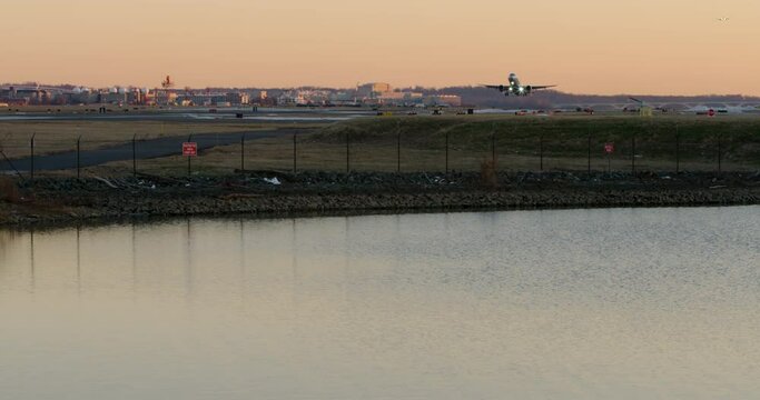 Commercial Jet Taking Off Over Pond At Sunset At Washington D.C.&rsquo;s DCA Airport