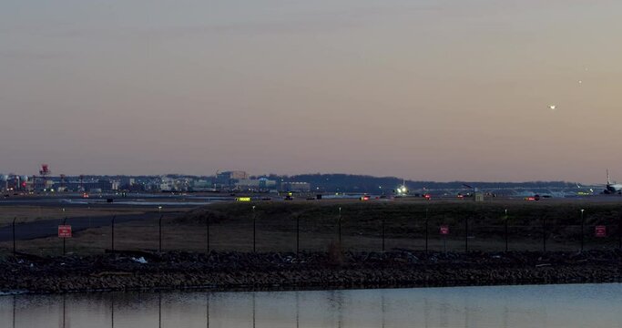 Plane Taking Off In Evening With Pan To Ducks Sitting On Water, Washington D.C.