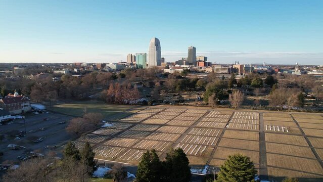 aerial orbit of winston salem nc, north carolina with god's acre in foreground