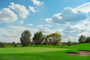 Fototapeta na wymiar landscape. golf course and sky with clouds. lawn grass.