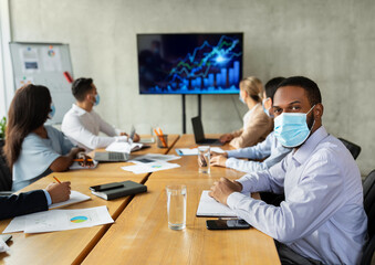 New Normal. Diverse Business People In Face Masks Having Conference In Office