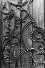 Decorative wrought iron fence elements on wooden doors