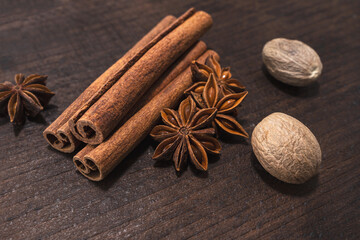 Anise, cinnamon and nutmeg on a brown kitchen board