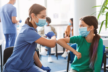 Teen Girl In Medical Mask Bumping Elbows Meeting Doctor