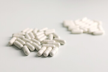 A pile of white medicine pills on white background