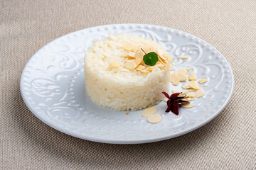 Obraz na płótnie Canvas Boiled rice with almonds. Classic side dish