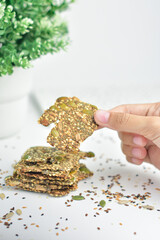 Chia Seed Crackers near ornamental plants on pure white background