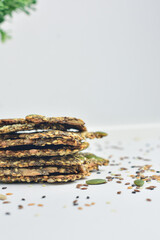 Chia Seed Crackers near ornamental plants on pure white background