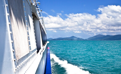 A fragment of a white yacht sailing on the azure sea