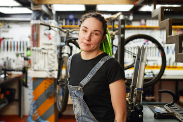 Fototapeta na wymiar Woman working in bicycle repair shop
