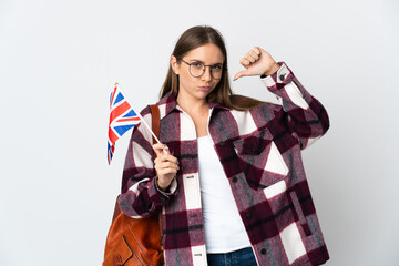 Young Lithuanian woman holding an United Kingdom flag isolated on white background proud and self-satisfied