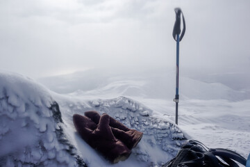 Gloves and a trekking stick in the snow near the Avachinsky Pass