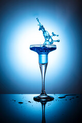 cocktail blue lagoon in a wine glass on a blue background