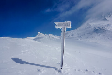 Frozen pillar on slope on Avachinsky volcano in winter