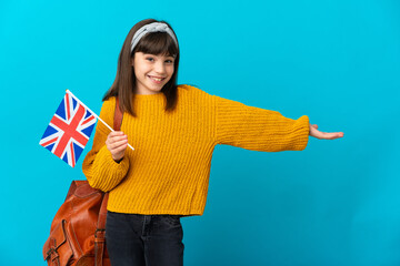 Little girl studying English isolated on blue background extending hands to the side for inviting to come