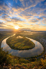 The Moselle Loop in Rhineland-Palatinate, Germany. Beautiful landscape shot at sunrise with fog in...