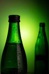 green bottle of water on a black background. green bottle of beer
