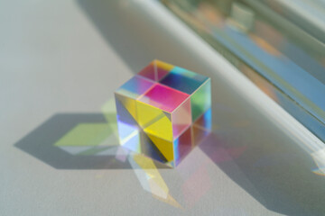 Cubic rainbow prism on a white background.