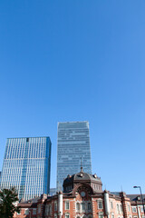 Tokyo station and high-rise buildings under the blue sky