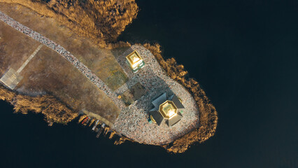 Aerial view of the old Church of the Transfiguration with a bell tower on the island of the Kanev reservoir, the flooded village of Gusintsy, Rzhishchev, Ukraine.