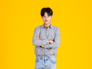 Studio shot of millennial Asian young male fashion model in stylish fashionable casual outfit...