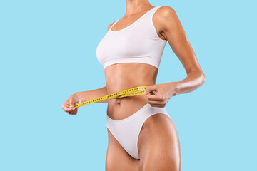 Closeup of Unrecognizable Lady Measuring Waist With Tape