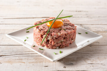 Beef steak tartare on wooden table