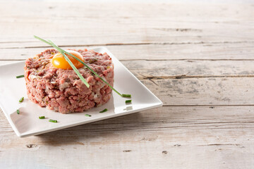 Beef steak tartare on wooden table. Copy space