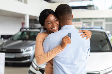 Best Present. Happy Black Woman Holding Car Key And Embracing Her Husband