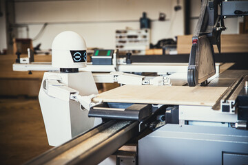 A robot works fully automatically in a carpentry workshop
