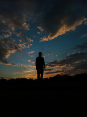 silhouette of a person and clouds