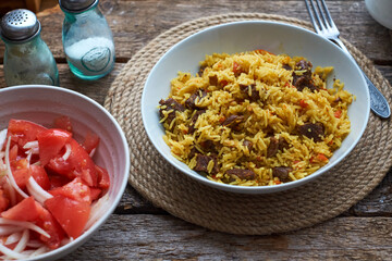 Pilaf. Side view, close-up, wooden background.