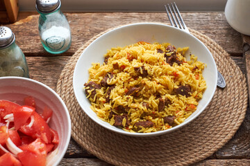 Pilaf. Side view, close-up, wooden background.