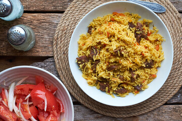 Pilaf. Side view, close-up, wooden background.