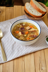 Mushroom soup with noodles. Side view, wooden background