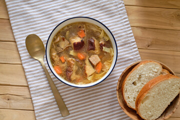 Mushroom soup with noodles. Top view, wooden background