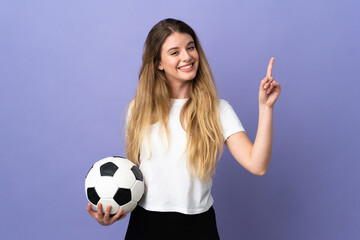 Young blonde football player woman isolated on purple background pointing back