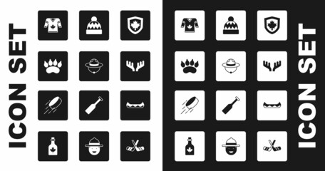 Set Canada flag on shield, Canadian ranger hat, Bear paw footprint, Hockey jersey, Deer antlers, Beanie, Kayak and puck icon. Vector