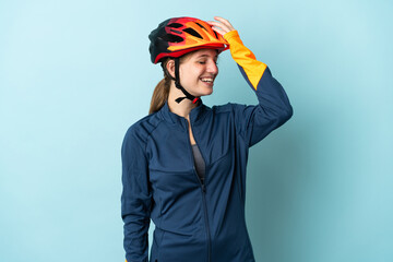 Young cyclist woman isolated on blue background has realized something and intending the solution