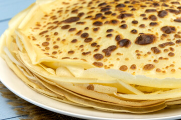 pile of pancakes in a plate on a blue background