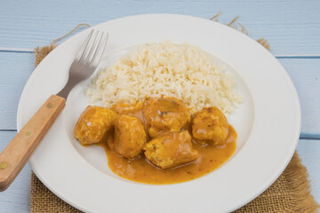 curry chicken dumpling with rice on a plate	