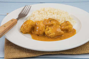 curry chicken dumpling with rice on a plate	