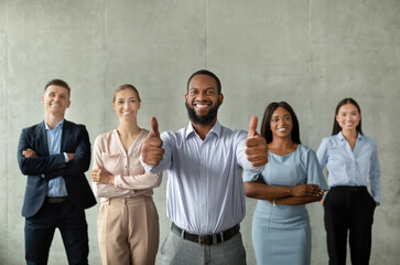 Successful Business Team. Black Male Ceo Posing With Smiliing Employees In Office