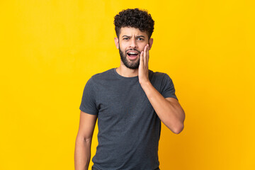 Young Moroccan man isolated on yellow background with surprise and shocked facial expression