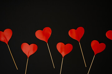 Fototapeta na wymiar Red paper heart shape decoration on black background. Love concept. Flat lay.
