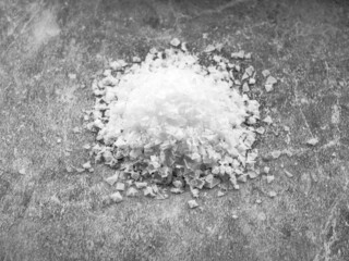 Heap of flake sea salt on gray background